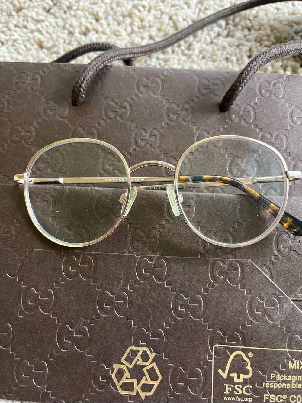 Round Gold Metal Eyeglasses with Tortoise Temples.